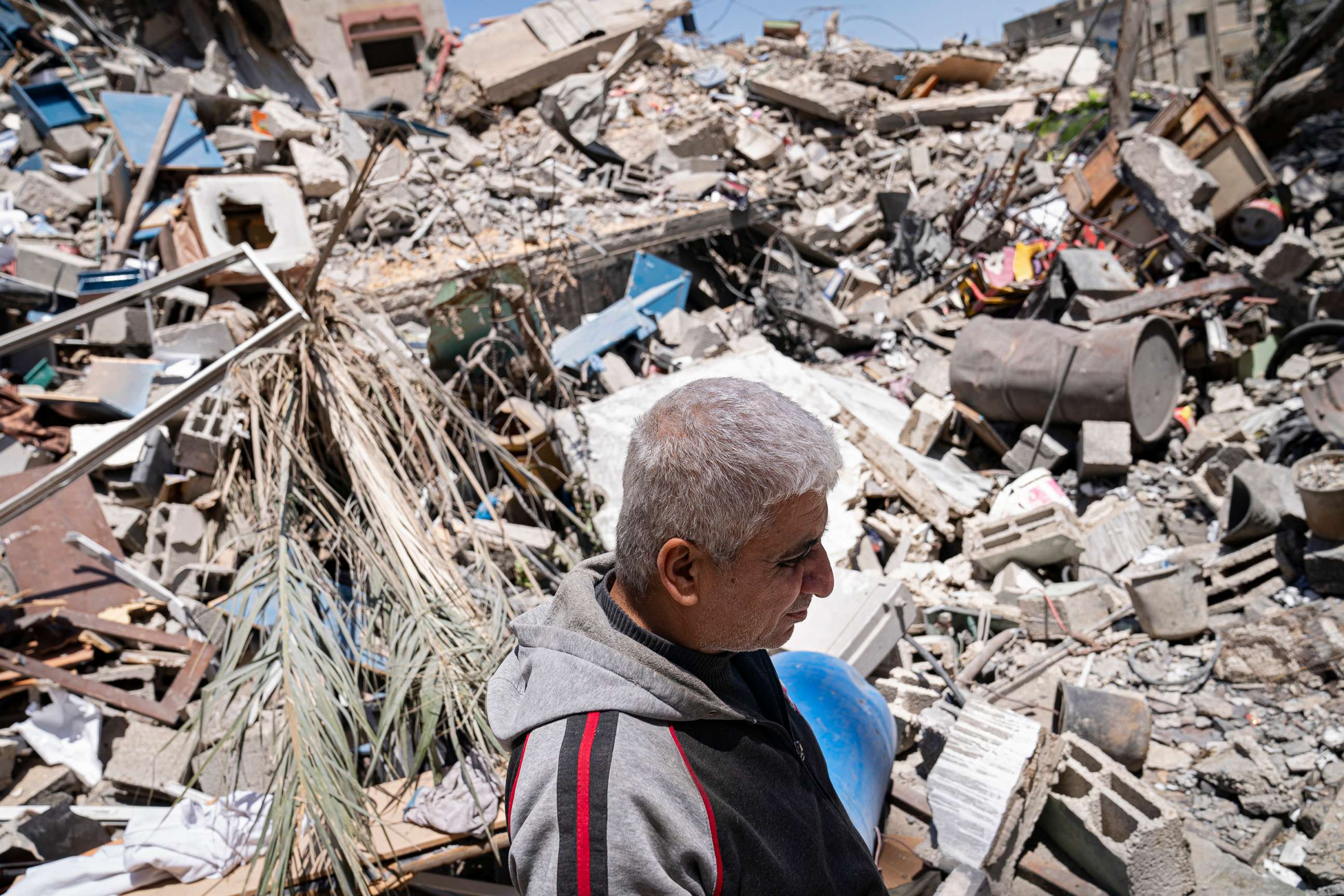 PHOTO: Jamaal Herzalla, 57, stands among the debris behind his shop of children's toys and books that was severely damaged when a neighboring building was destroyed by an airstrike, May 25, 2021, in Gaza City.