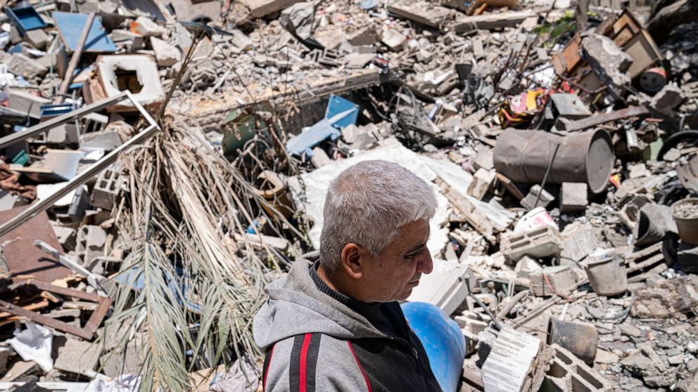PHOTO: Jamaal Herzalla, 57, stands among the debris behind his shop of children's toys and books that was severely damaged when a neighboring building was destroyed by an airstrike, May 25, 2021, in Gaza City.