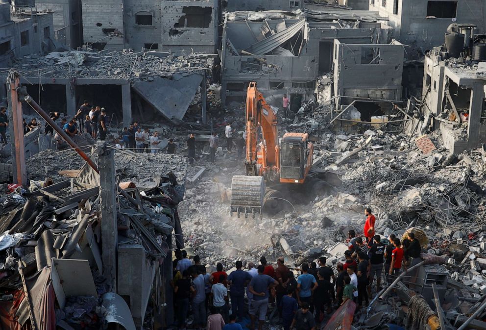 PHOTO: Palestinians search for casualties at the site of Israeli strikes on houses, in Khan Younis, in the southern Gaza Strip, Oct. 25, 2023.