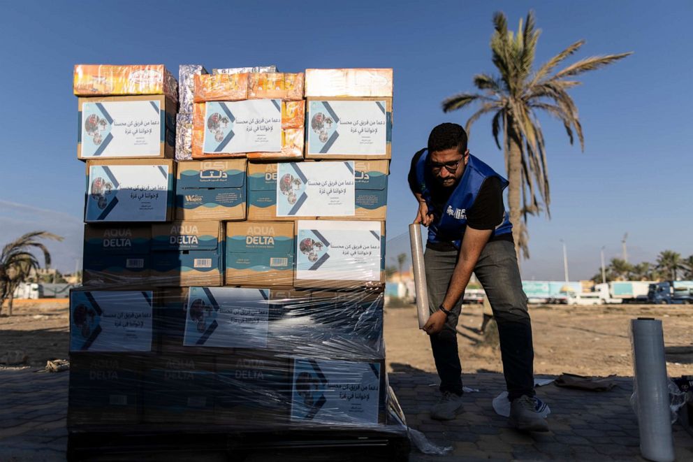 PHOTO: Volunteers load food and supplies onto trucks in an aid convoy for Gaza on Oct. 16, 2023, in North Sinai, Egypt.