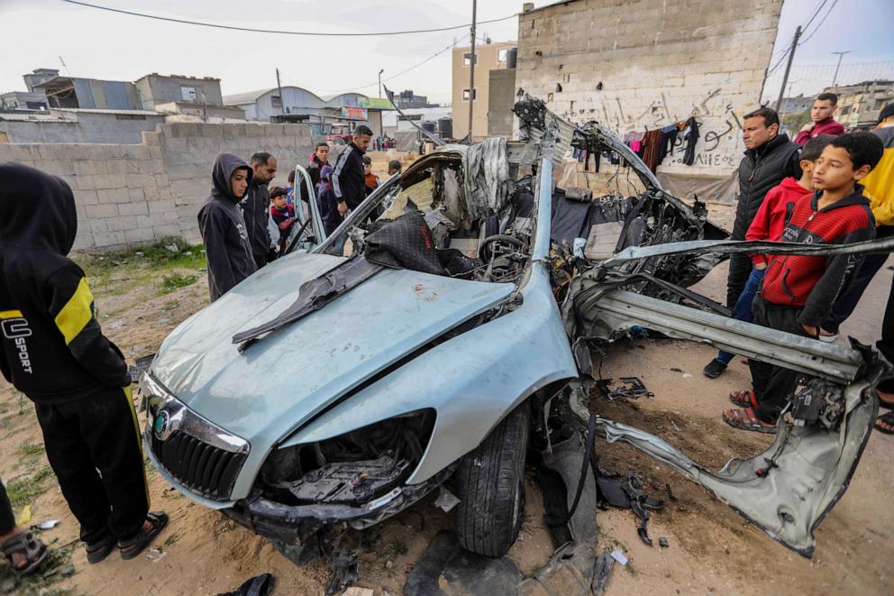 PHOTO: Citizens inspect a car that was destroyed by Israeli air strikes on Jan. 21, 2024 in Rafah, Gaza.