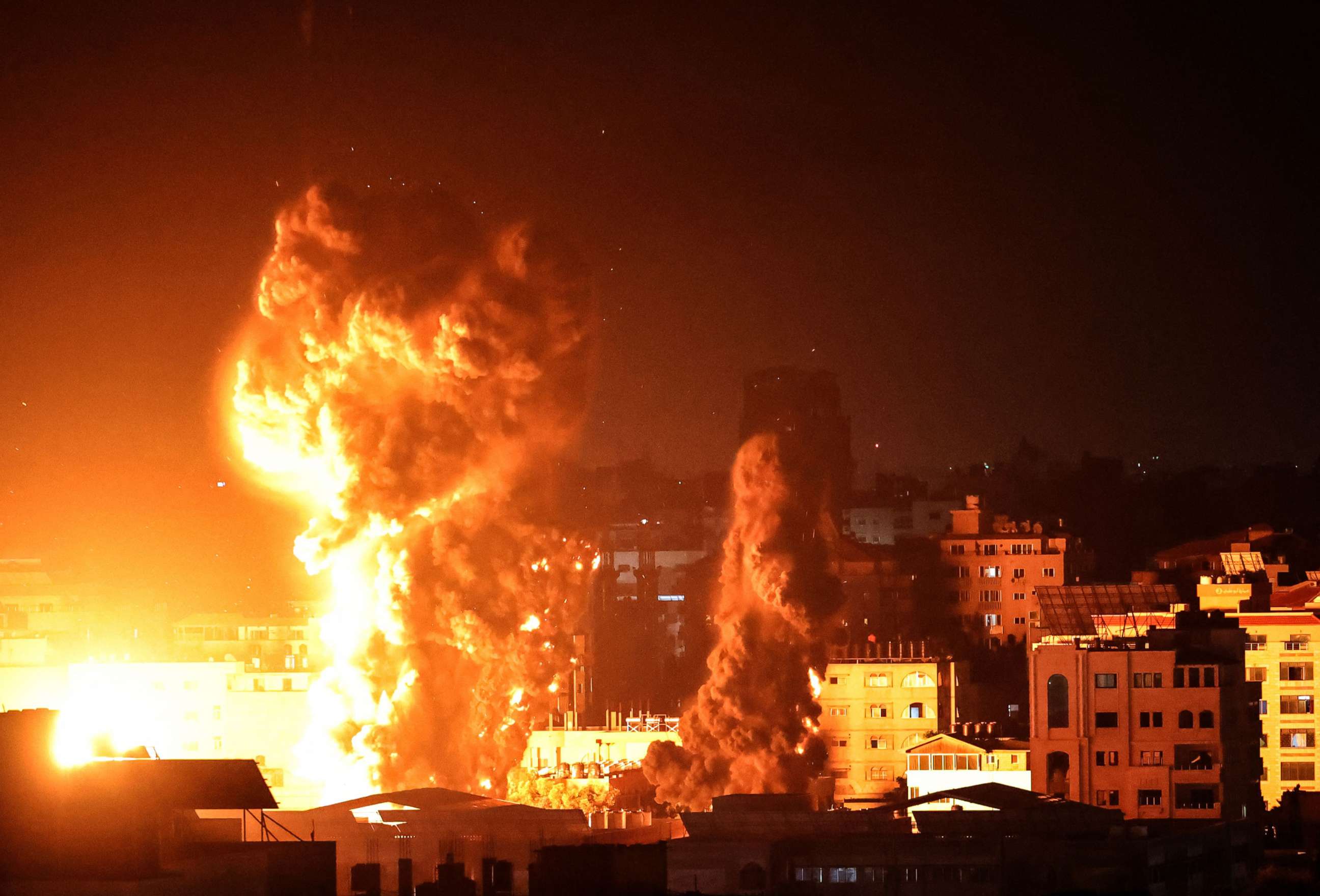 PHOTO: Fire and smoke rise above buildings in Gaza City as Israeli warplanes target the Palestinian enclave, May 17, 2021.