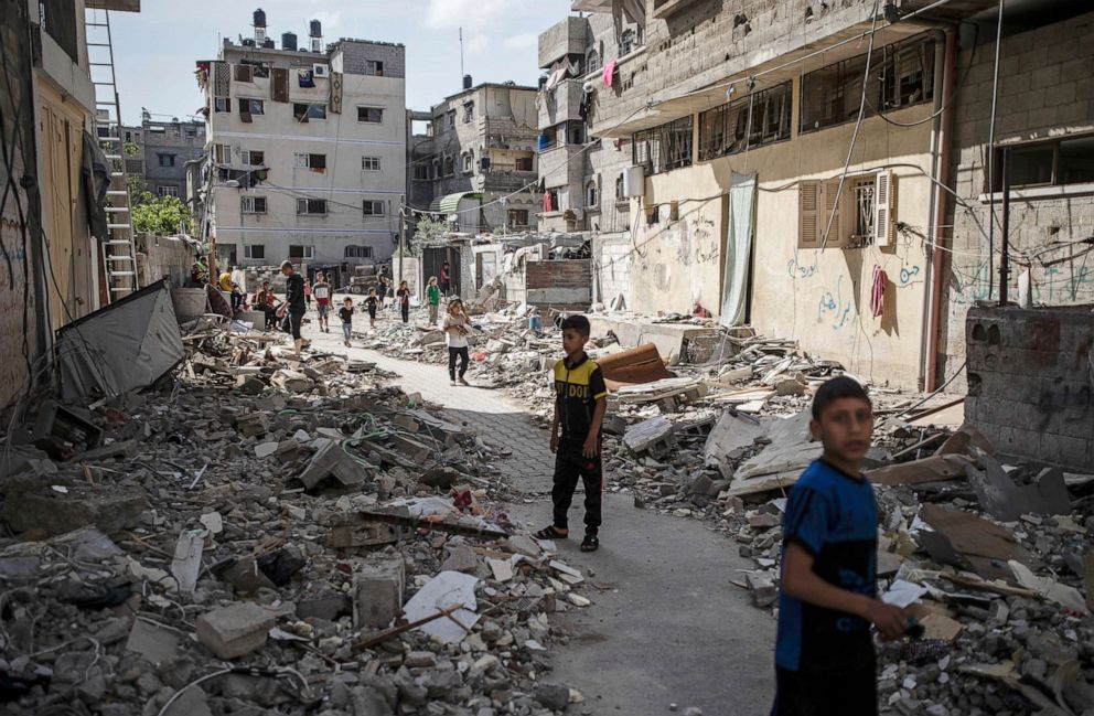 PHOTO: Palestinian children walk next to rubble from a house was that was hit by early morning Israeli airstrikes, in Gaza City, May 17, 2021.