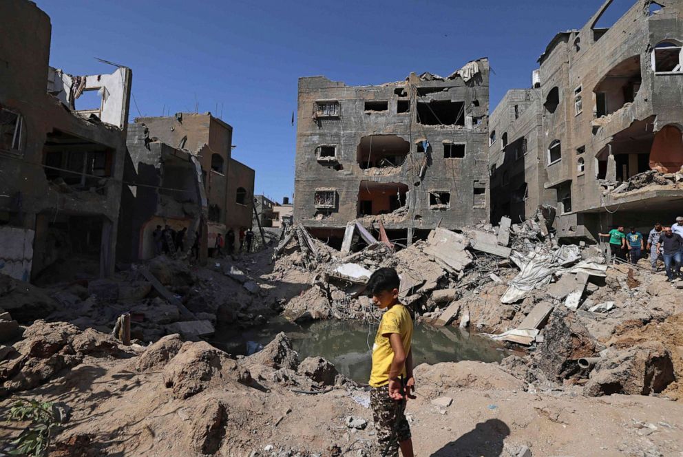 PHOTO: A Palestinian child stands amidst the rubble of buildings, destroyed by Israeli strikes, in Beit Hanun in the northern Gaza Strip on May 21, 2021.