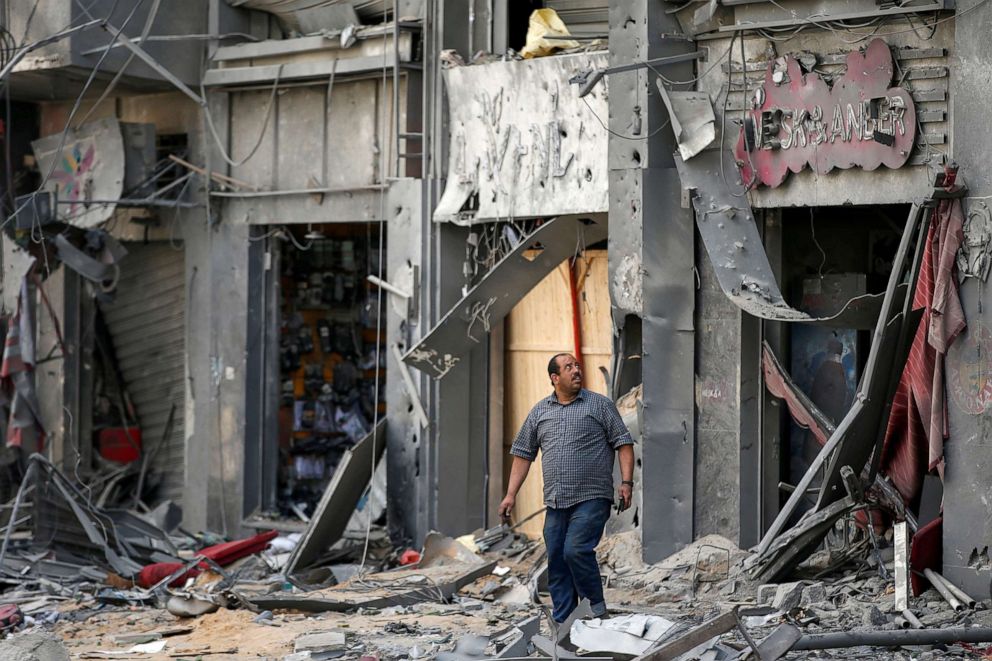 PHOTO: A Palestinian man views the damage in the aftermath of Israeli air strikes that destroyed a tower building, amid a flare-up of Israeli-Palestinian violence, in Gaza City, May 13, 2021.