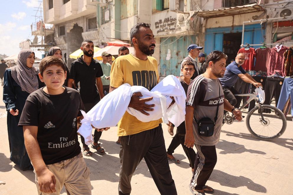 PHOTO: A Palestinian man carries a body during a funeral after an Israeli strike on a school housing displaced Palestinians in Gaza City's Zaytoun neighbourhood on Sept. 21, 2024.