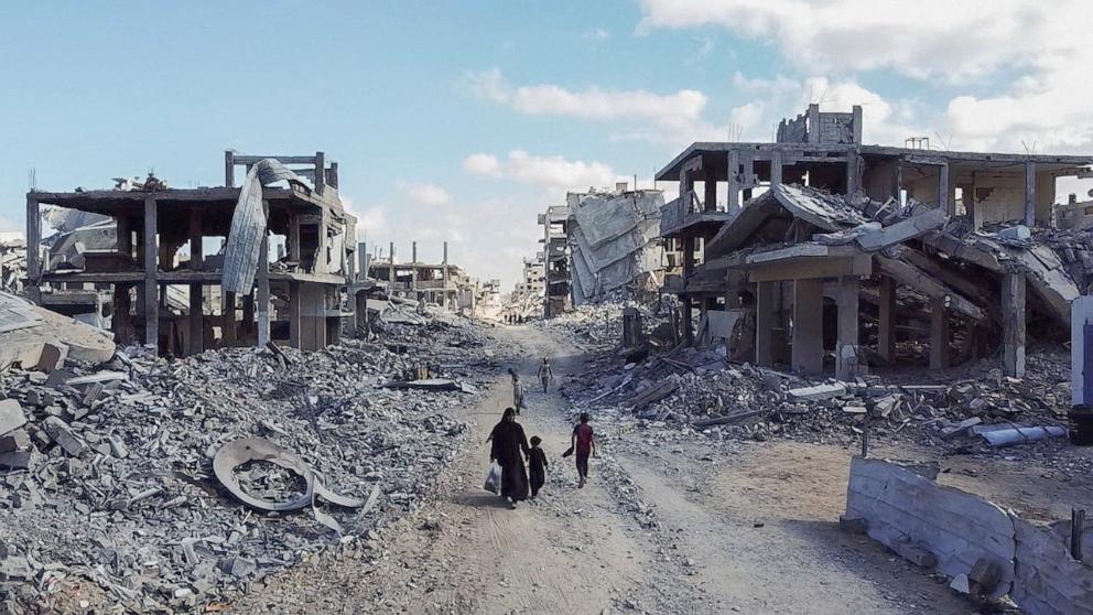 PHOTO: A drone view shows people walking through a destroyed residential neighbourhood, following the withdrawal of the Israeli forces from the area, amid a ceasefire between Israel and Hamas in Gaza, in Gaza City, Oct. 18, 2025.