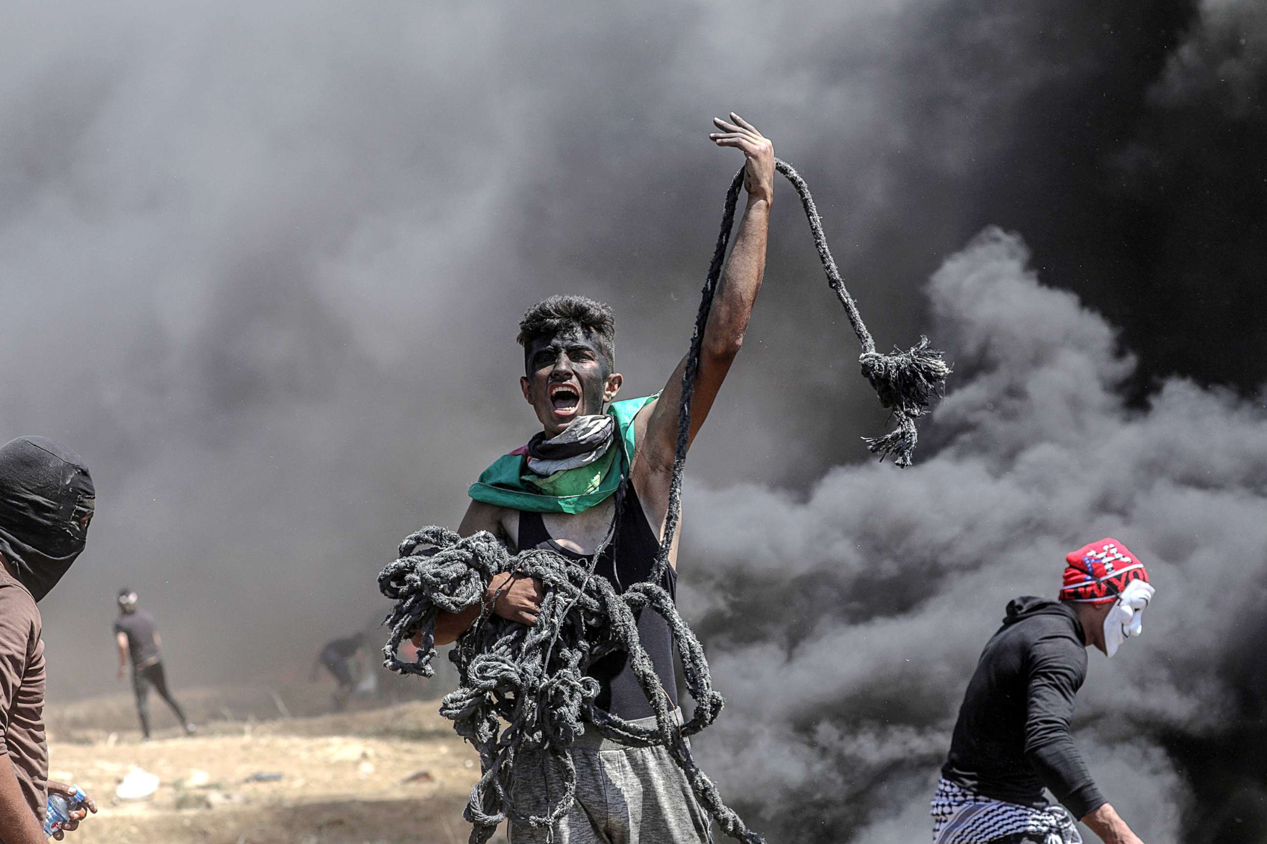 PHOTO: A Palestinian protester holds a rope during clashes after protests near the border with Israel in the east of Gaza Strip, 14 May 2018.