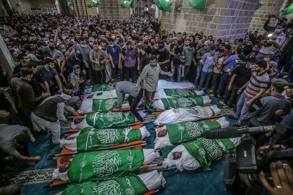 PHOTO: Palestinians attend a funeral for people killed in an Israeli air strike in Gaza City, May 13, 2021.