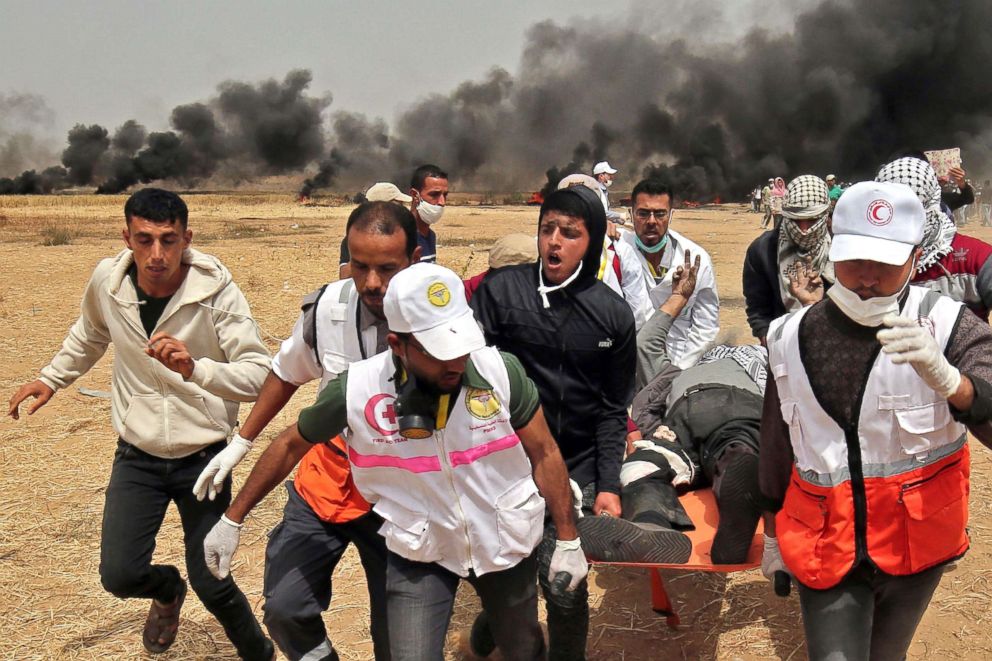 PHOTO: Palestinian medics evacuate a wounded protester during clashes with Israeli forces on April 20, 2018, east of Khan Yunis, in the southern Gaza Strip. 