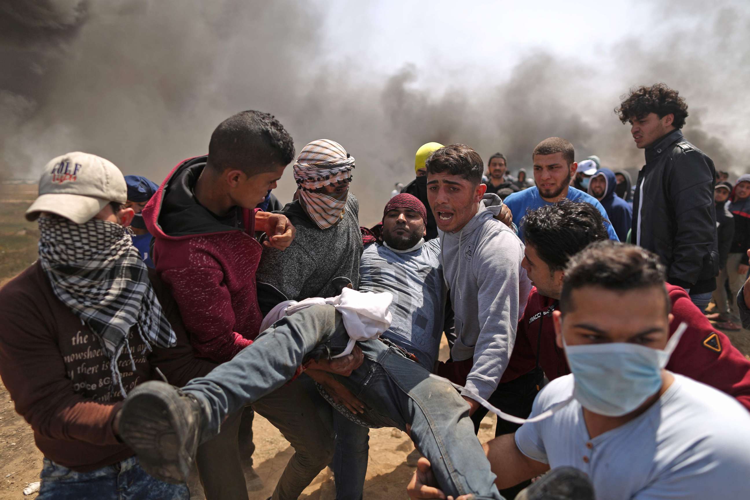 PHOTO: Palestinian men carry an injured protester after clashes with Israeli forces at the Israel-Gaza border during a protest, east of Gaza City in the Gaza strip, April 6, 2018.