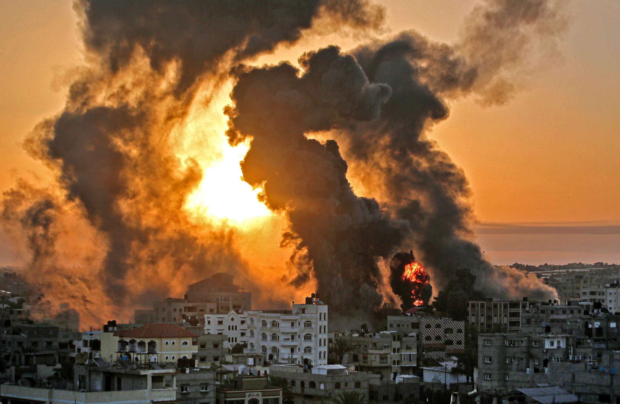 PHOTO: A fire rages at sunrise in Khan Yunish following an Israeli airstrike on targets in the southern Gaza strip, early on May 12, 2021.