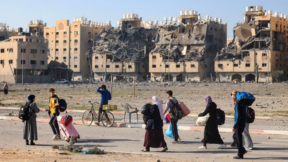 PHOTO: Residents of the Qatari-funded Hamad Town residential complex in Khan Yunis in the southern Gaza Strip, carry some of their belongings as they flee their homes after an Israeli strike, on Dec. 2, 2023.