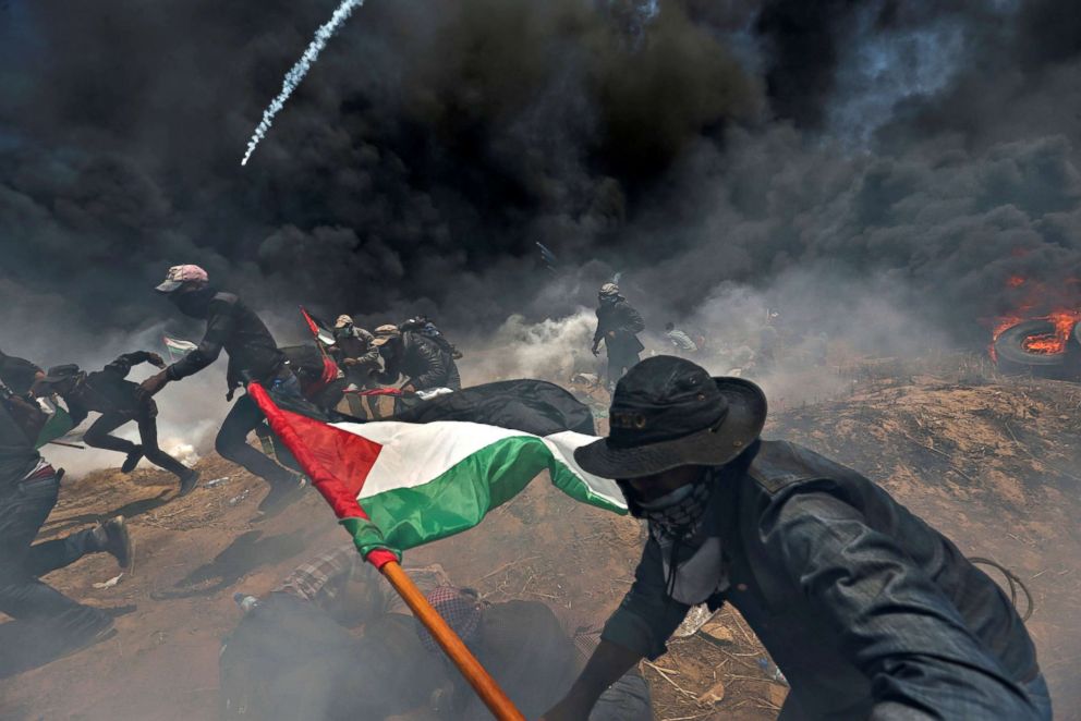 PHOTO: Palestinian demonstrators run for cover from Israeli fire and tear gas during a protest against the U.S. embassy move to Jerusalem at the Israel-Gaza border in the southern Gaza Strip, May 14, 2018. 