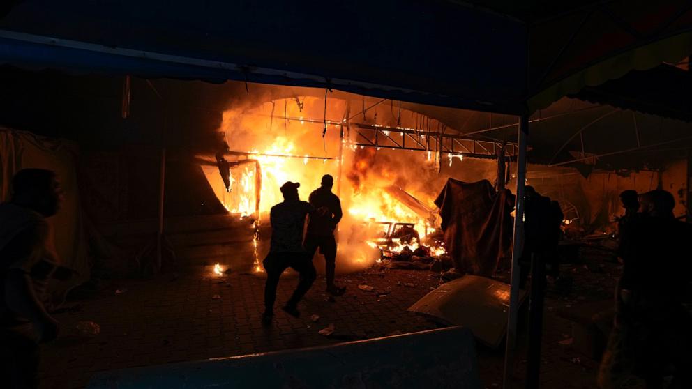 PHOTO: Palestinians react to a fire after an Israeli strike hit a tent area in the courtyard of Al Aqsa Martyrs hospital in Deir al Balah, Gaza Strip, Monday, Oct. 14, 2024.