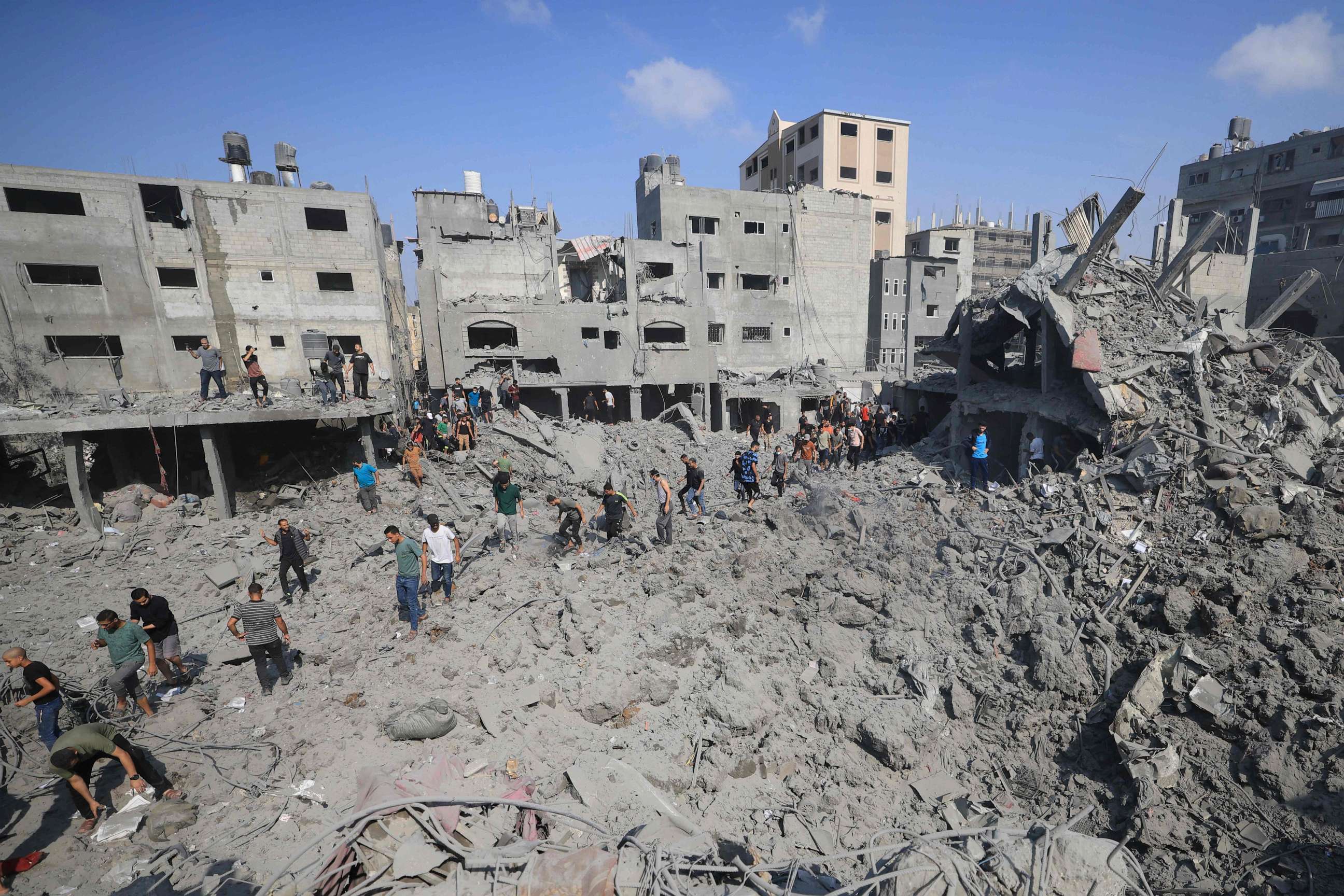 PHOTO: People check the rubble of buildings destroyed in an Israeli strike on the Bureij refugee camp in the central Gaza Strip on November 2, 2023, as battles between Israel and the Palestinian Hamas movement continue. (