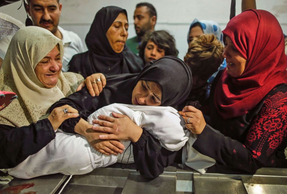 The mother of eight-month-old Leila al-Ghandour, a Palestinian child who died of tear gas inhalation during clashes in East Gaza the previous day, holds her at the morgue of al-Shifa hospital in Gaza City on May 15, 2018. 
