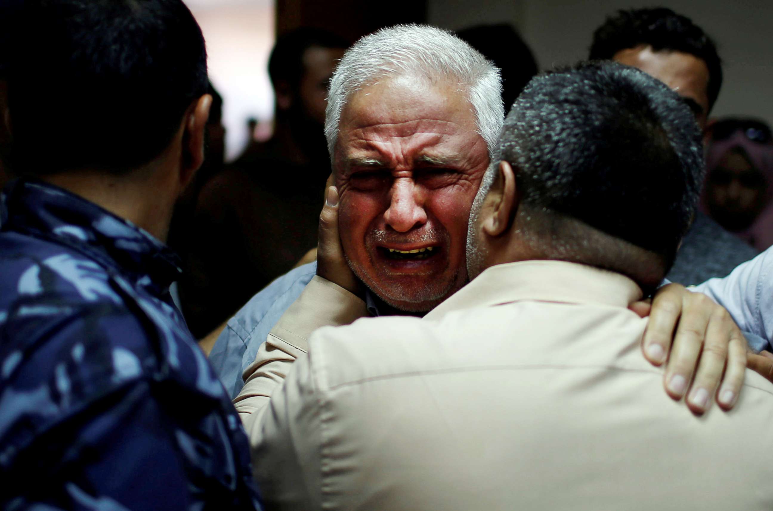 PHOTO: A relative of Palestinian Ahmed al-Rantisi, killed during a protest at the Israel-Gaza border, is consoled at a hospital in the northern Gaza Strip on May 14, 2018. 