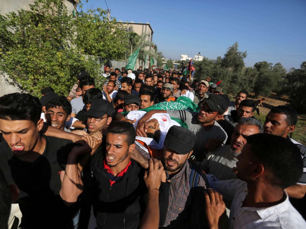 Mourners carry the body of Palestinian Mahmoud Abu Taima, who was killed by Israeli troops during clashes in a tent city protest where Palestinians demanded the right to return to their homeland, May 14, 2018, in the Gaza Strip.