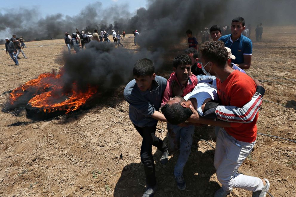 PHOTO: A wounded Palestinian demonstrator is evacuated during a protest against U.S. embassy move to Jerusalem in the southern Gaza Strip May 14, 2018. 