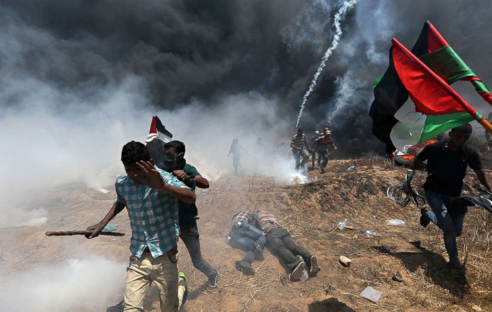 PHOTO: Palestinian demonstrators run for cover during a protest against the U.S. embassy move to Jerusalem at the Israel-Gaza border in the southern Gaza Strip, May 14, 2018. 