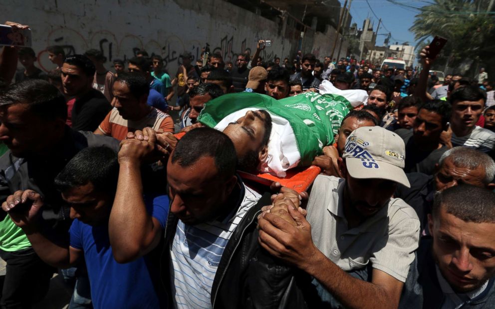 PHOTO: Mourners carry the body of a Palestinian, who was killed during a protest against the U.S embassy move to Jerusalem at the Israel-Gaza border, during his funeral in the central Gaza Strip on May 15, 2018. 