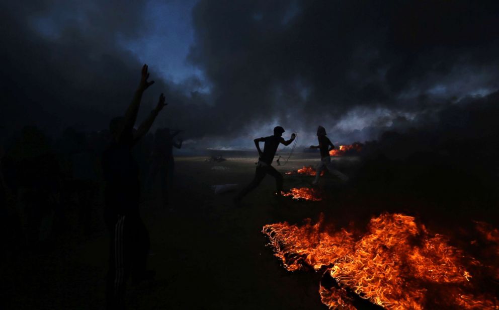 PHOTO: Palestinian demonstrators run during a protest at the Israel-Gaza border in the southern Gaza Strip on May 15, 2018. 