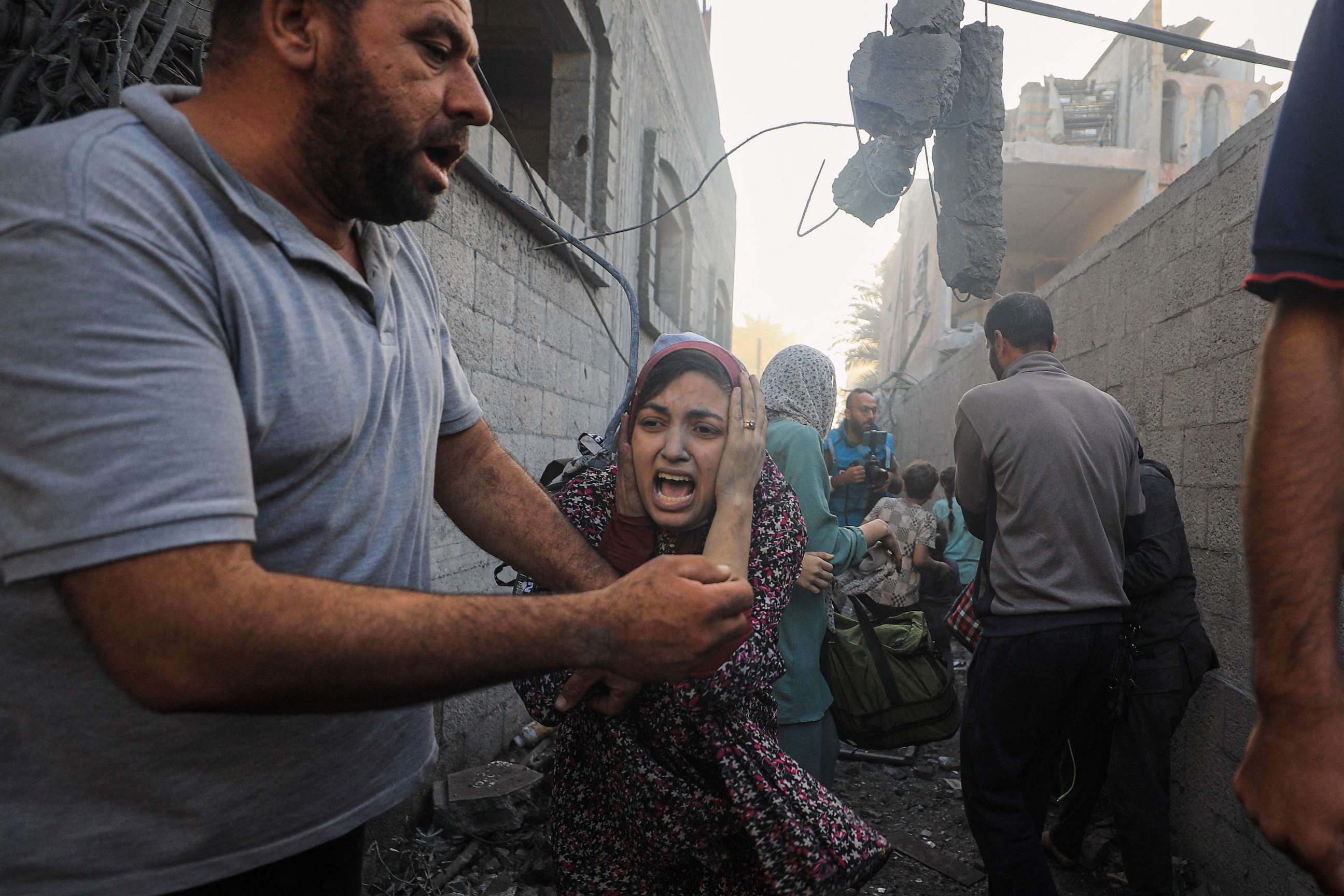 PHOTO: People flee following Israeli air strikes on a neighbourhood in the al-Maghazi refugee camp in the central Gaza Strip on Nov. 6, 2023.