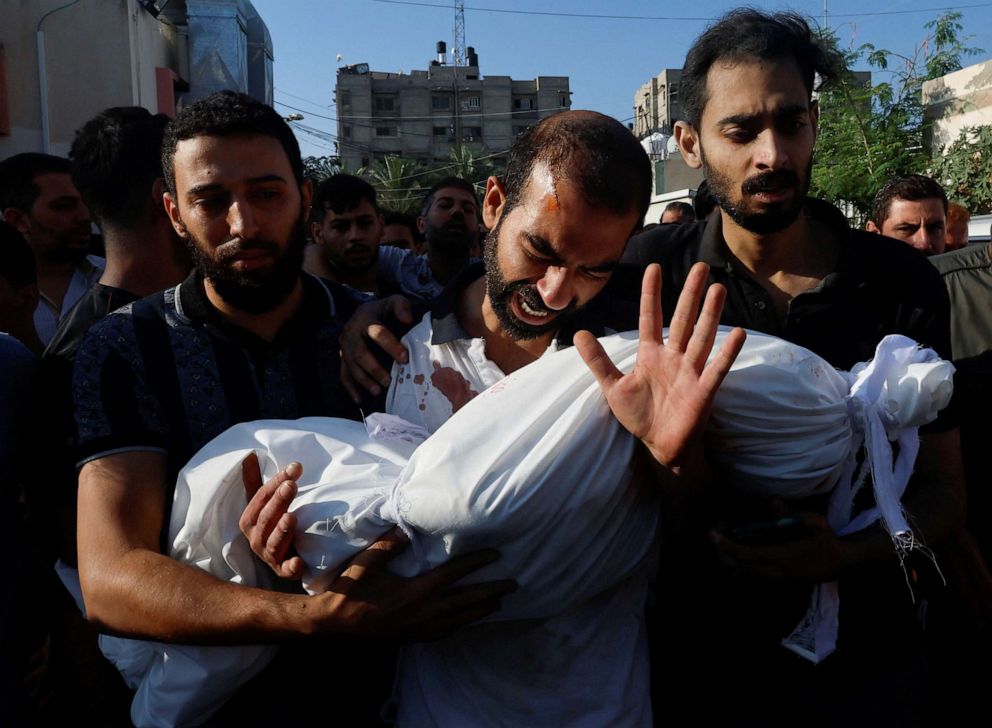 PHOTO: The father of Alma Al Majayda, 3, killed in Israeli strikes, reacts while carrying her body during her funeral, in Khan Younis in the southern Gaza Strip, Oct. 19, 2023.