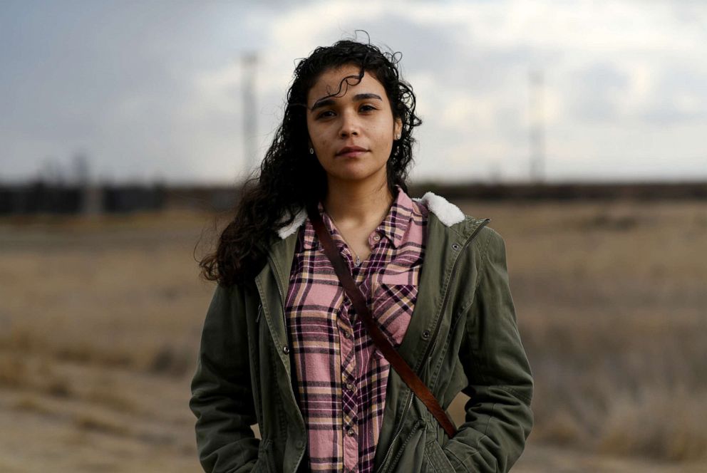 PHOTO: Valeria Murguia, 21, a university student, poses for a photograph in a field near her home in McFarland, California, U.S., December 17, 2020.