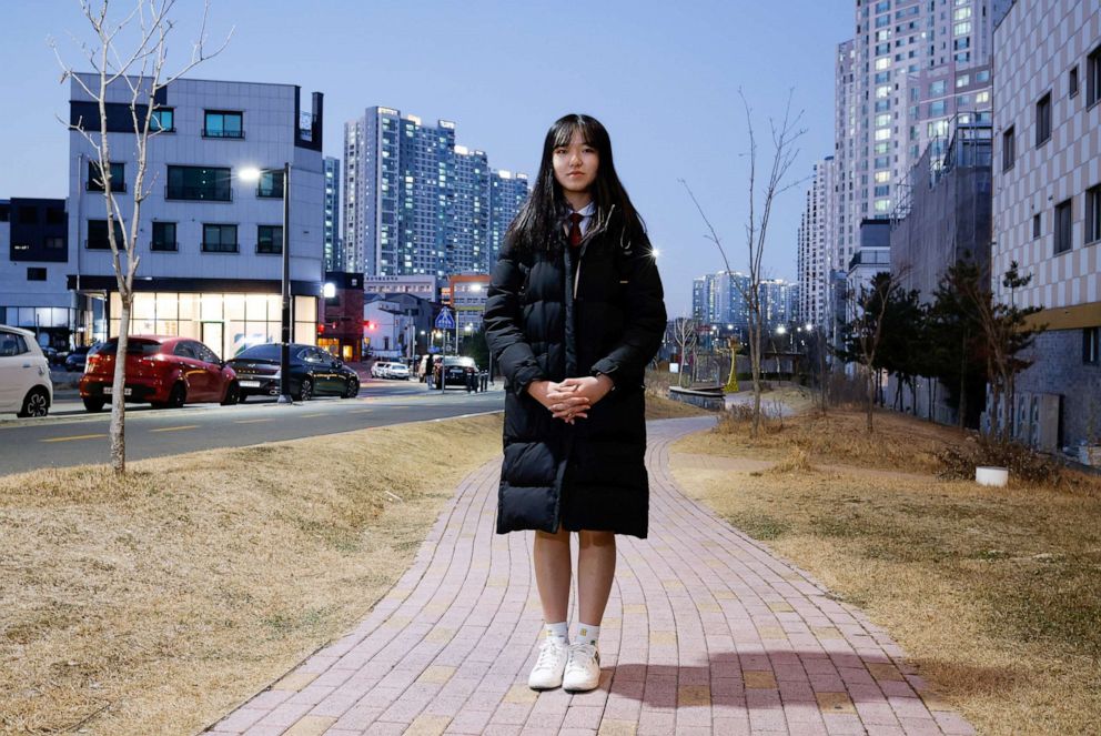 PHOTO: Lee Ga-hyeon, 17, a high school student and a fan of the K-pop boyband BTS, poses for a photograph on a street in Cheonan, South Korea, Dec. 16, 2020.