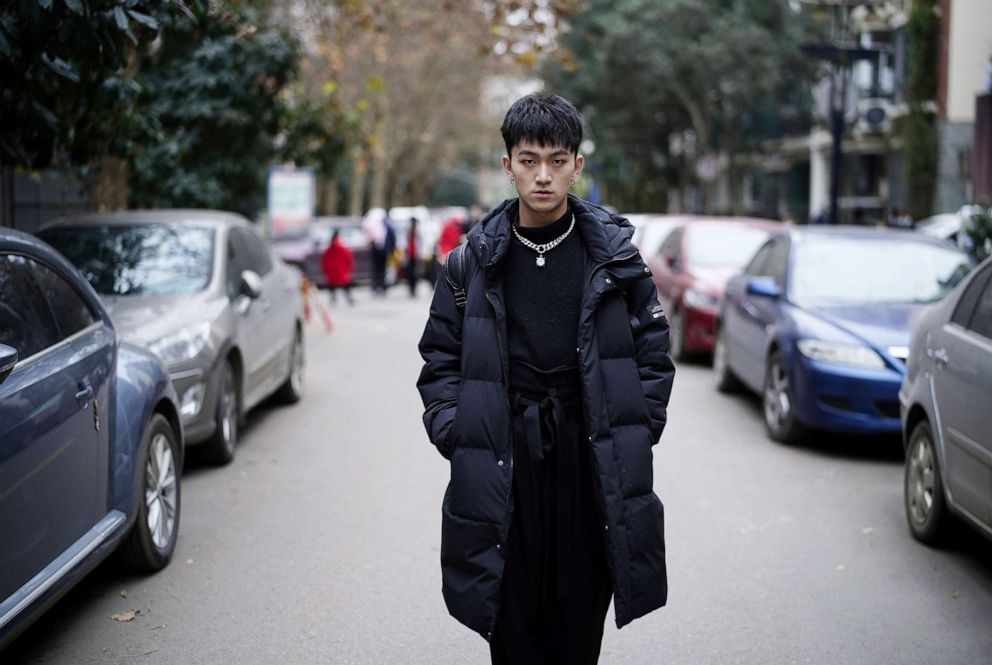 PHOTO: Xiong Feng, 22, a dancer, poses for a photograph on a street in Wuhan, Hubei province, China, December 14, 2020.