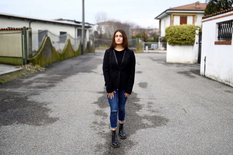 PHOTO: Elisa Dossena, 23, a student, poses for a photo on a street in Crema, Italy, Dec. 15, 2020.