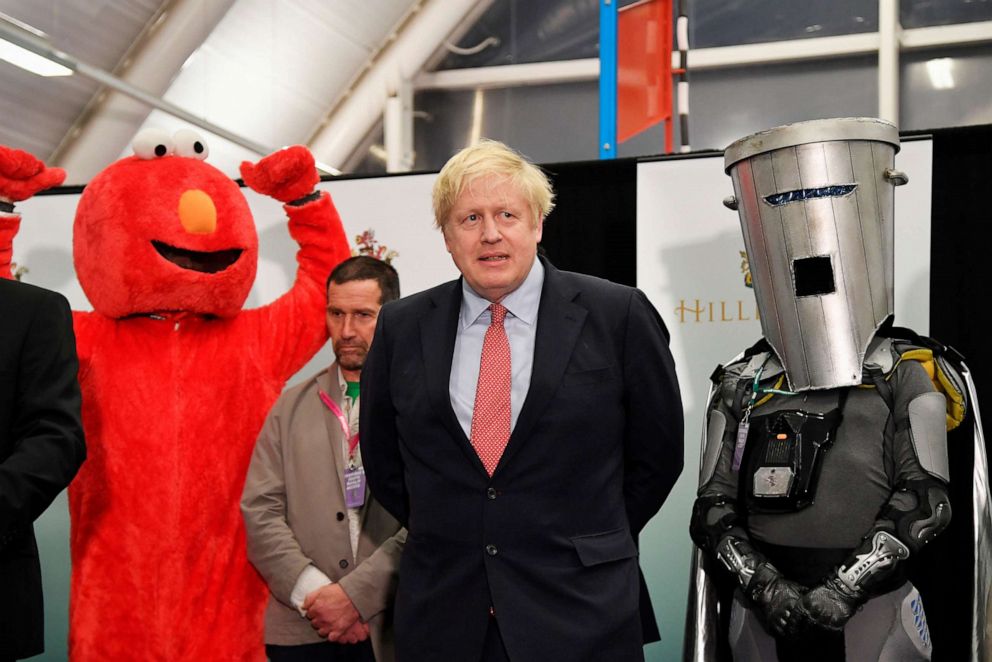 PHOTO: British Prime Minister Boris Johnson looks on, between Independent candidate Bobby "Elmo" Smith and Independent candidate Count Binface, after winning his seat of Uxbridge and South Ruislip in Uxbridge, Britain, Dec. 13, 2019.