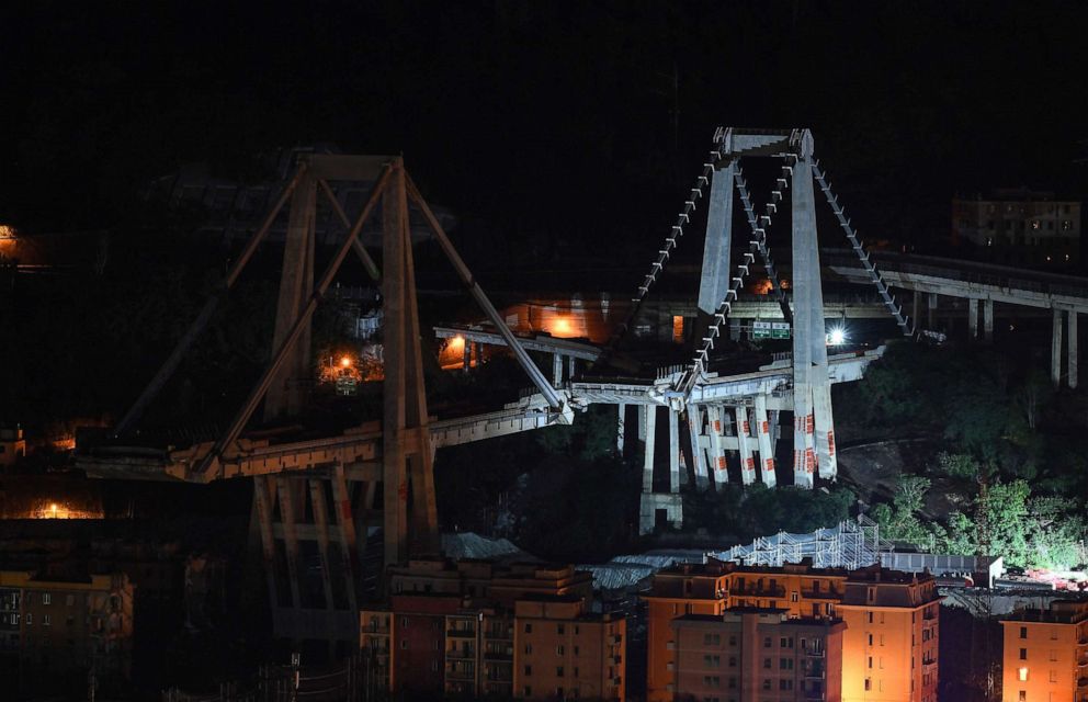 PHOTO: A general night view shows the remaining eastern pylons of Genoa's Morandi motorway bridge, which are to be destroyed with explosives, seen in red on the concrete structure below, June 27, 2019 in Genoa, Italy.