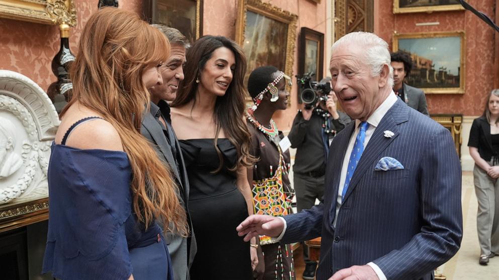 PHOTO: Britain's King Charles III speaks with, from left, Charlotte Tilbury, and George and Amal Clooney during a reception for the winners of the King's Trust Awards 2025 at Buckingham Palace, London, June 25, 2025. 