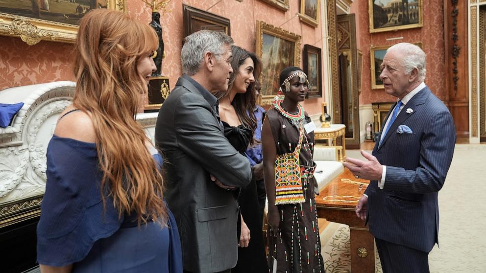PHOTO: Britain's King Charles speaks with Charlotte Tilbury, George Clooney and Amal Clooney during a reception for the winners of the King's Trust Awards 2025, at Buckingham Palace, London, Britain, June 25, 2025. 