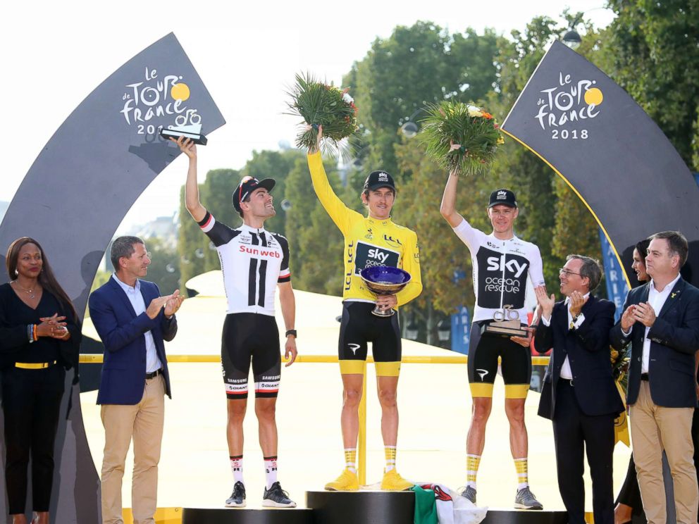PHOTO: Winner Geraint Thomas (C) of Great Britain, Second Placed Tom Dumoulin (L) of The Netherlands and third placed Chris Froome (R) of Great Britain celebrate on the podium of the Tour de France in Paris, July 29, 2018.