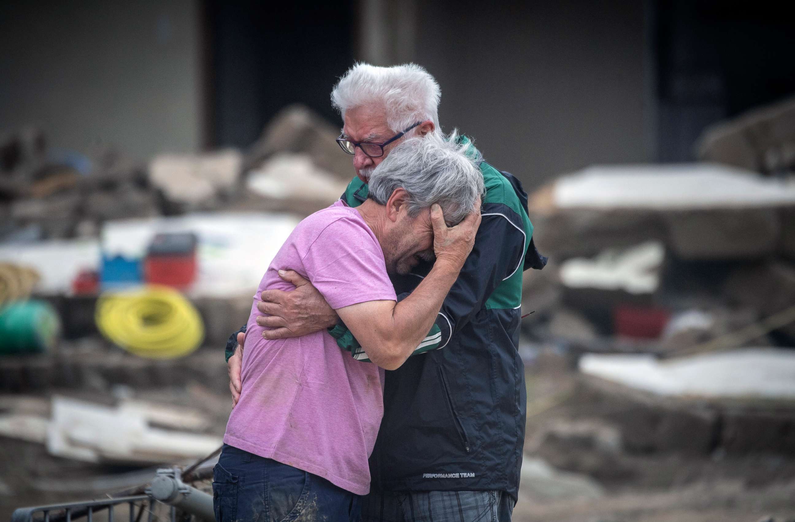 PHOTO: Two brothers weep in each other's arms in front of their parents' house, which was destroyed by the flood in Altenahr, Germany, July 19, 2021.