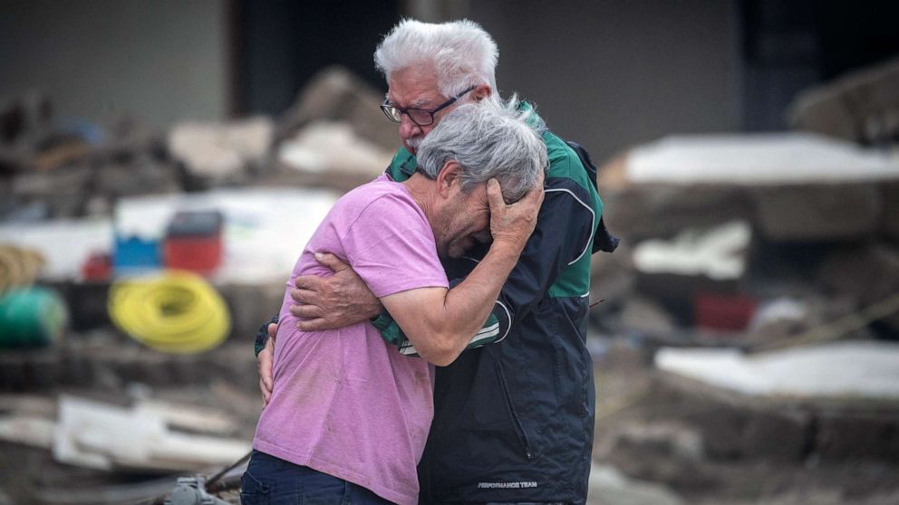 PHOTO: Two brothers weep in each other's arms in front of their parents' house, which was destroyed by the flood in Altenahr, Germany, July 19, 2021.