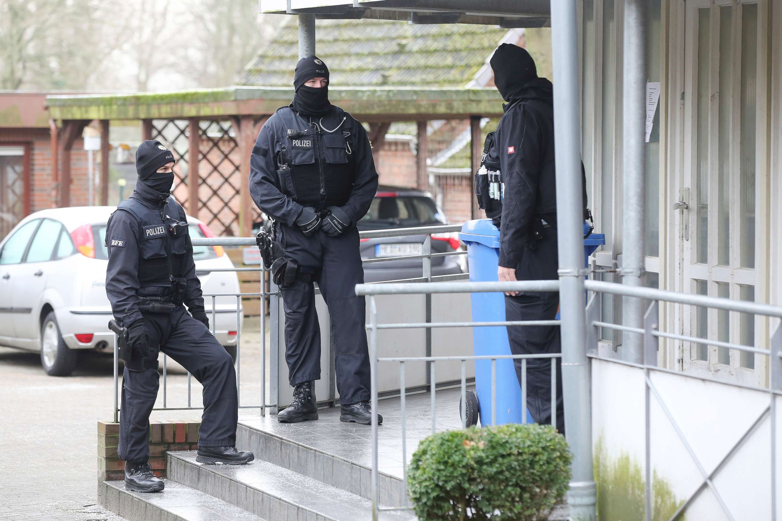 PHOTO: Police officer stand in front of at building during a raid in the village Meldorf, Germany, Jan. 30, 2019.