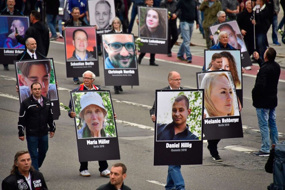 PHOTO: Demonstrators hold up placards showing portraits of victims of refugees during a protest organised by the far-right Alternative for Germany (AfD) party, on Sept. 1, 2018 in Chemnitz, Germany.