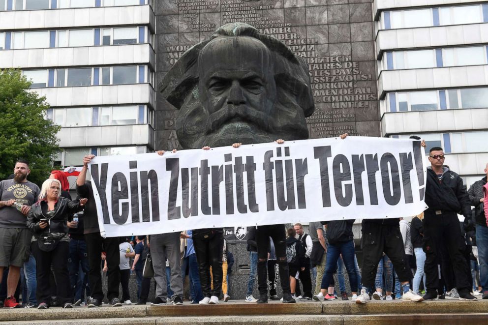 PHOTO: Protesters hold a banner with slogan 'No entry for terror' in front of a statue of Karl Marx in Chemnitz, Germany, Aug. 27, 2018.