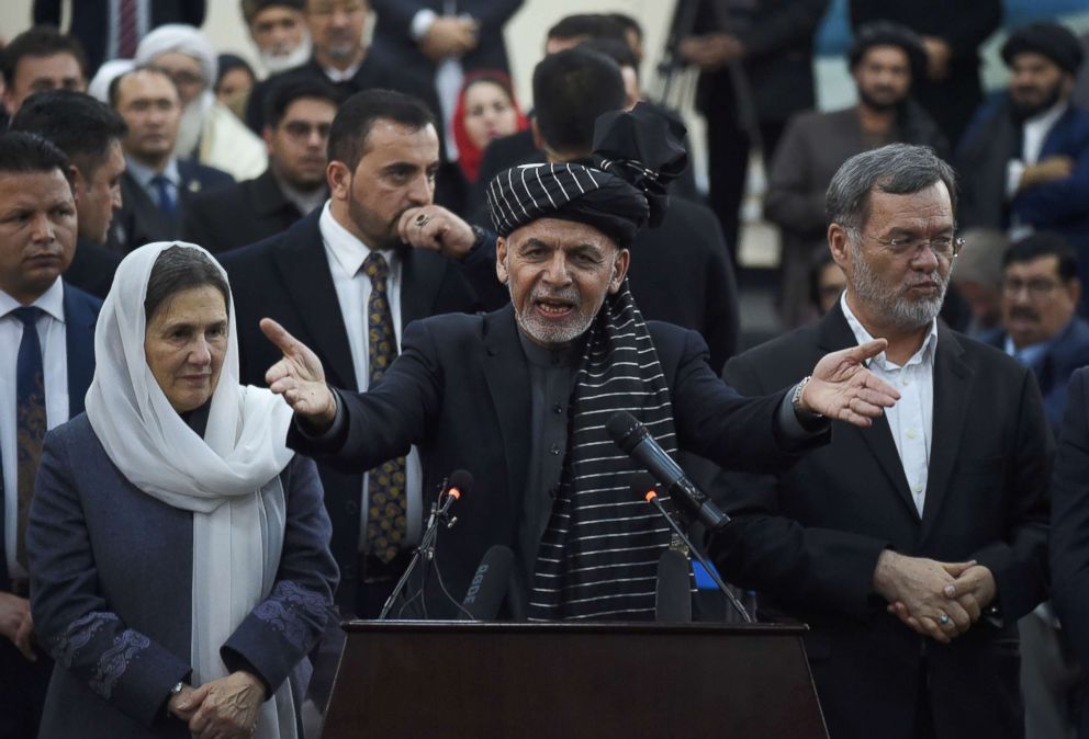 PHOTO: Afghan President Ashraf Ghani (C) speaks to media as Afghan First Lady Rula Ghani  (L) and Sarwar Danish his current second vice president (R) look on at the Independent Electoral Commission office in Kabul, Jan. 20, 2019.