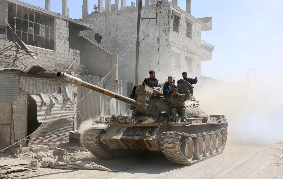 PHOTO: Syrian government forces deploy in the captured town of Beit Sawa in the Eastern Ghouta region on the outskirts of Damascus, March 14, 2018.