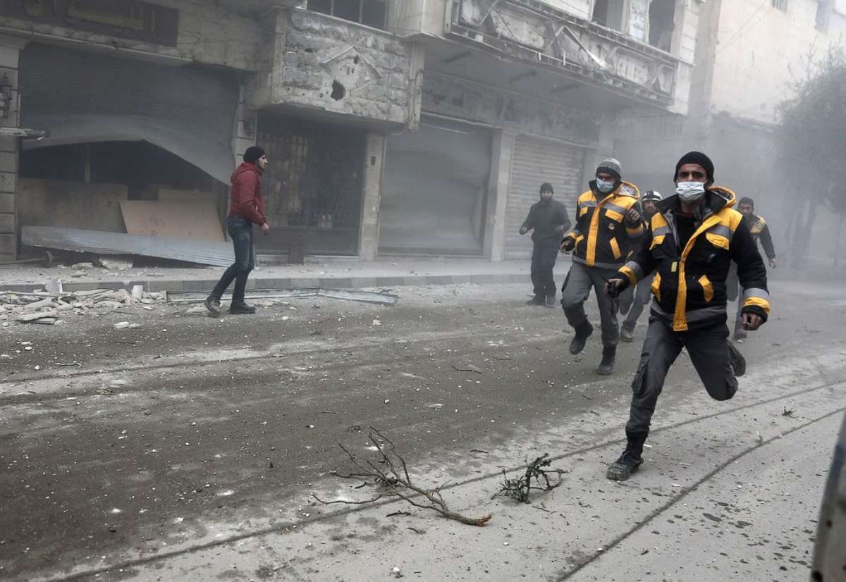 PHOTO: Syrian rescuers and civilians run at the site of Syrian government bombardments in Hamouria, in the besieged Eastern Ghouta region on the outskirts of the capital Damascus on Feb. 22, 2018. 