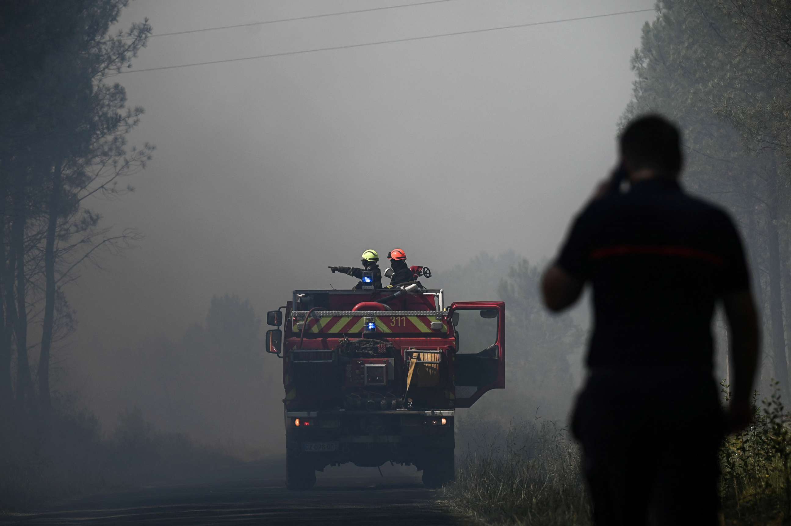 PHOTO: Firefighters stand guard to monitor fire outbreaks and restarts near Saint-Magne, southwestern France, on Aug. 10, 2022.