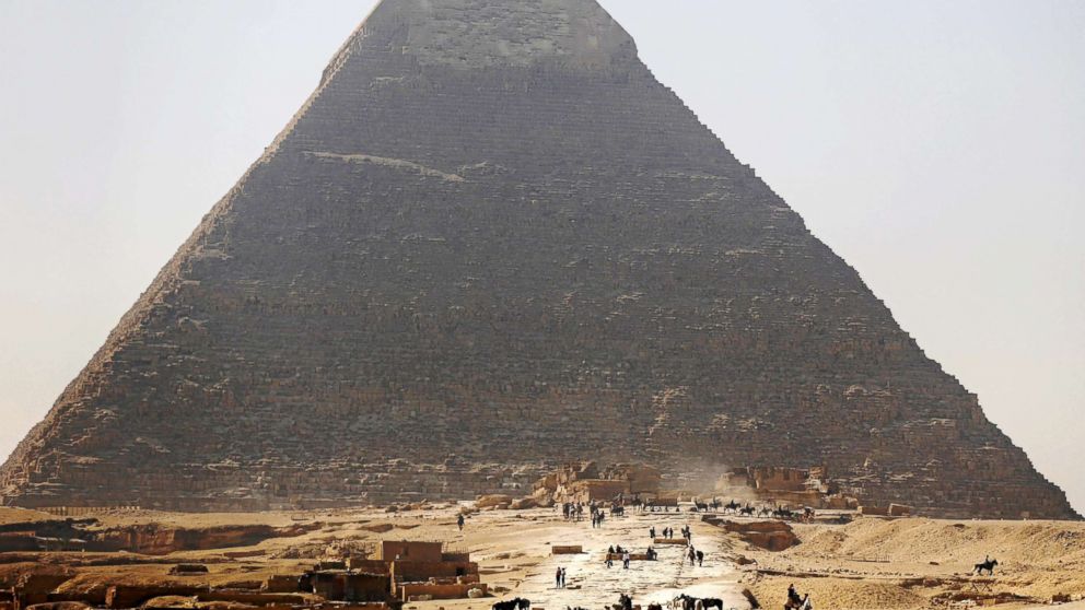 Tourists visit the Great Pyramid of Giza, the oldest and largest at the Giza pyramid complex, on the outskirts of Cairo, Egypt, March 2, 2016.