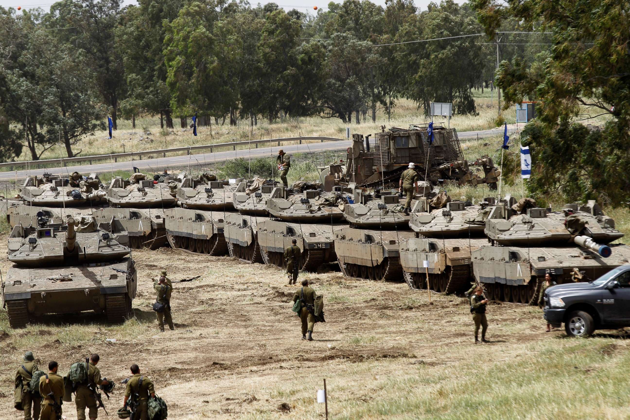 PHOTO: Israeli soldiers walk by Merkava Mark IV tanks during a military drill in the Israeli-annexed Golan Heights on May 1, 2018.