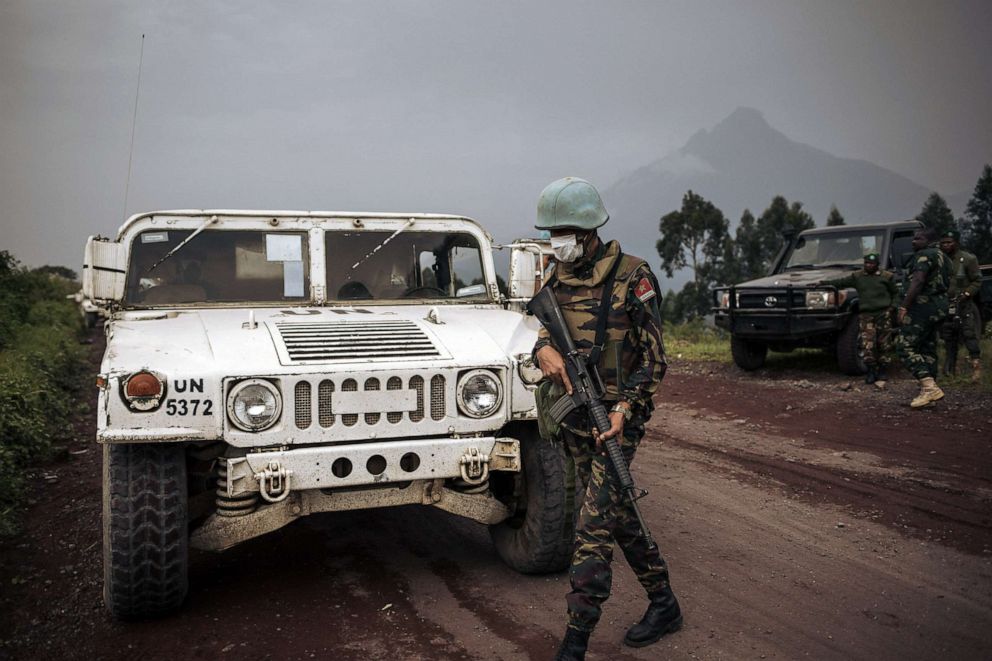 PHOTO: United Nations troops and Congolese soldiers retrieve bodies on the edge of the Virunga National Park near the village of Kibumba, North Kivu province, Democratic Republic of the Congo, on Feb. 22, 2021.